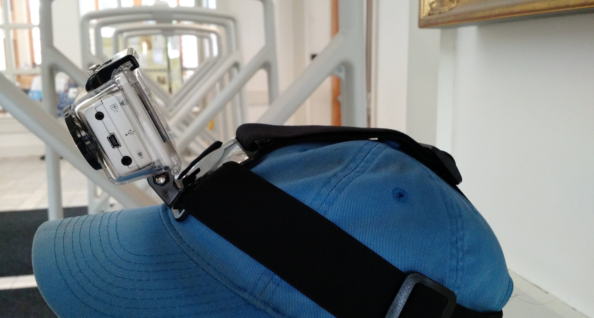 A camera is strapped to a worn baseball hat